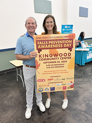 Council Member Alcorn Holding Up a Sign