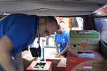 HPD Sgt. Jim Babb unloads supplies with Officer E.J. Joseph and Officer Ted Wang in background